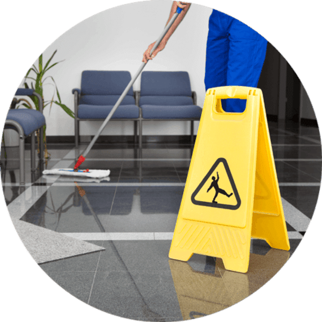 A mop and wet floor sign on a freshly cleaned reception floor