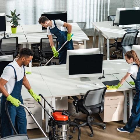 The 21st Century Cleaning team vacuuming, mopping and wiping down desks in an open-plan office